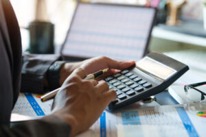 a photo of an accountant using his calculator