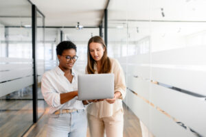 a photo of two coworkers chatting during a coffee break