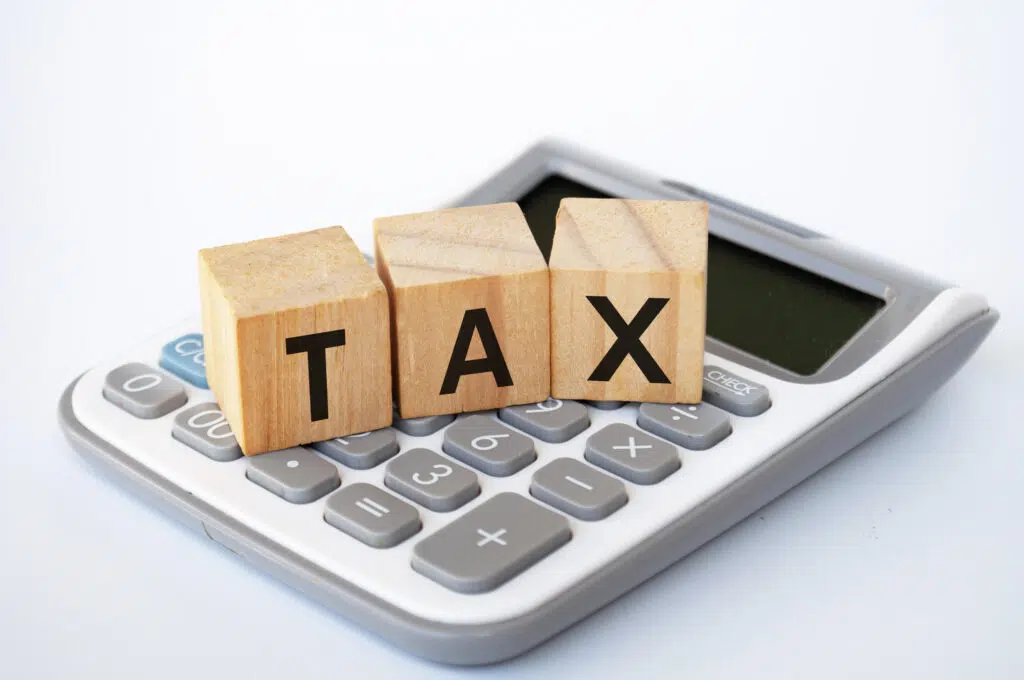 tax wordings on wooden cubes with a calculator in the background